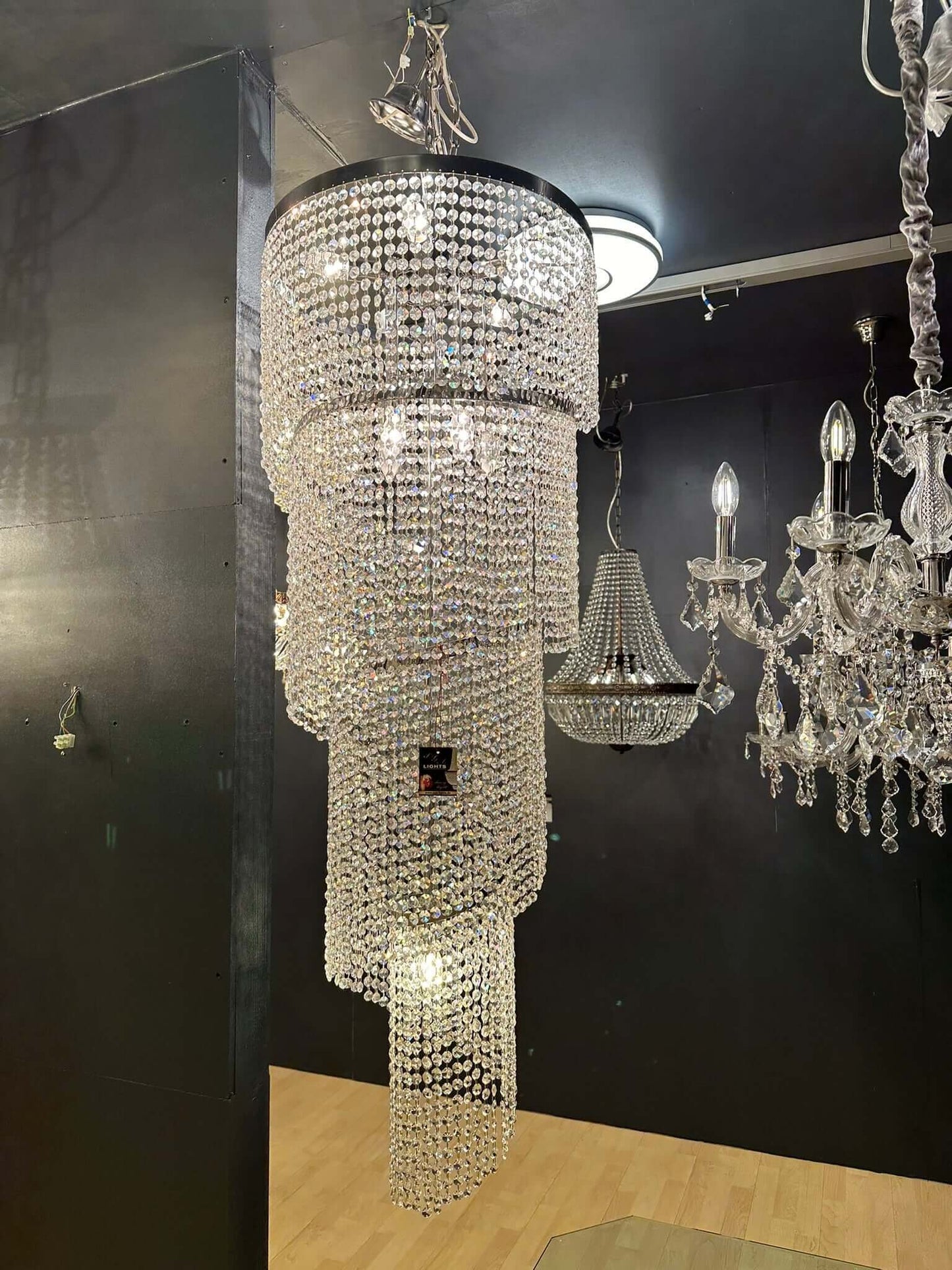 Twister chandelier with sparkling crystals in showroom, chrome silver finish, Ø50cm, height 145cm, dimmable, E14 LED/halogen.