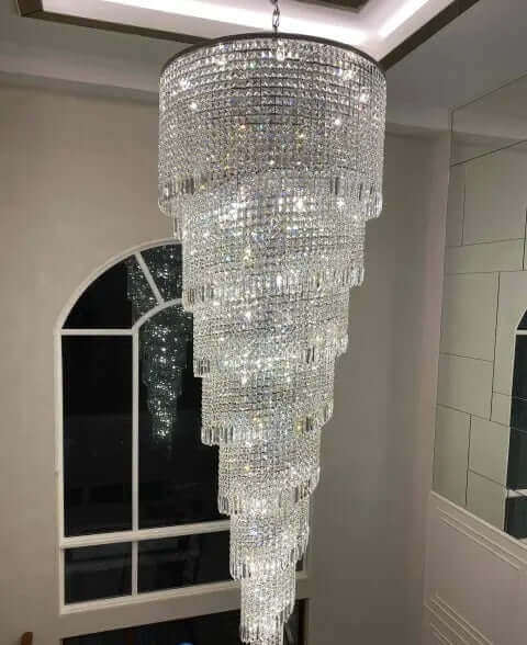 Luxurious Kristall Twister chandelier with spiral design, perfect for staircases, featuring brass, chrome, and high-quality lead crystal.